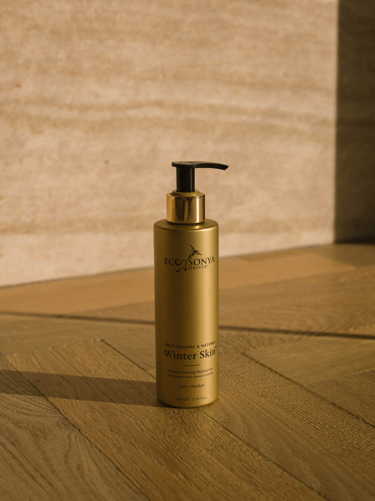 ECO BY SONYA Winter Skin Gradual Tanning Moisturiser in a warm lifestyle setting