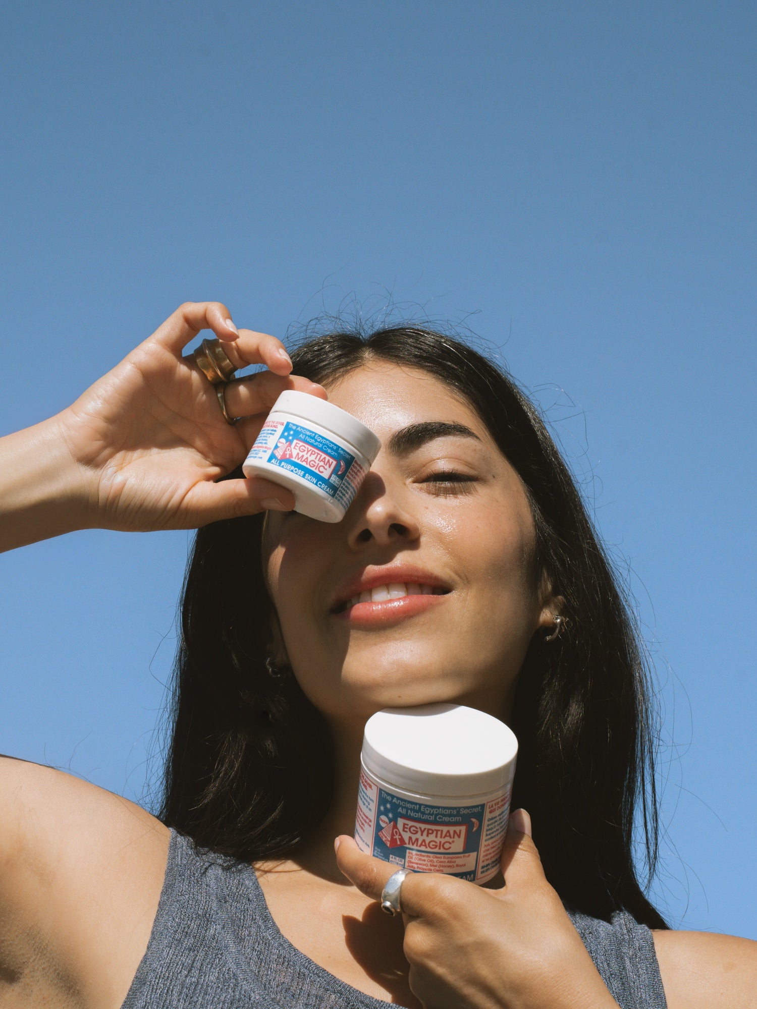Egyptian Magic All Purpose Skin Cream jars held in hands