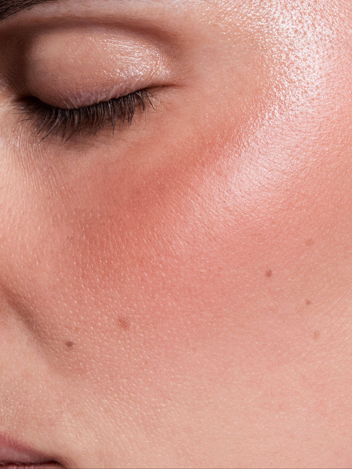 FARA HOMIDI Baume Stick creating a luminous peachy glow on the cheek