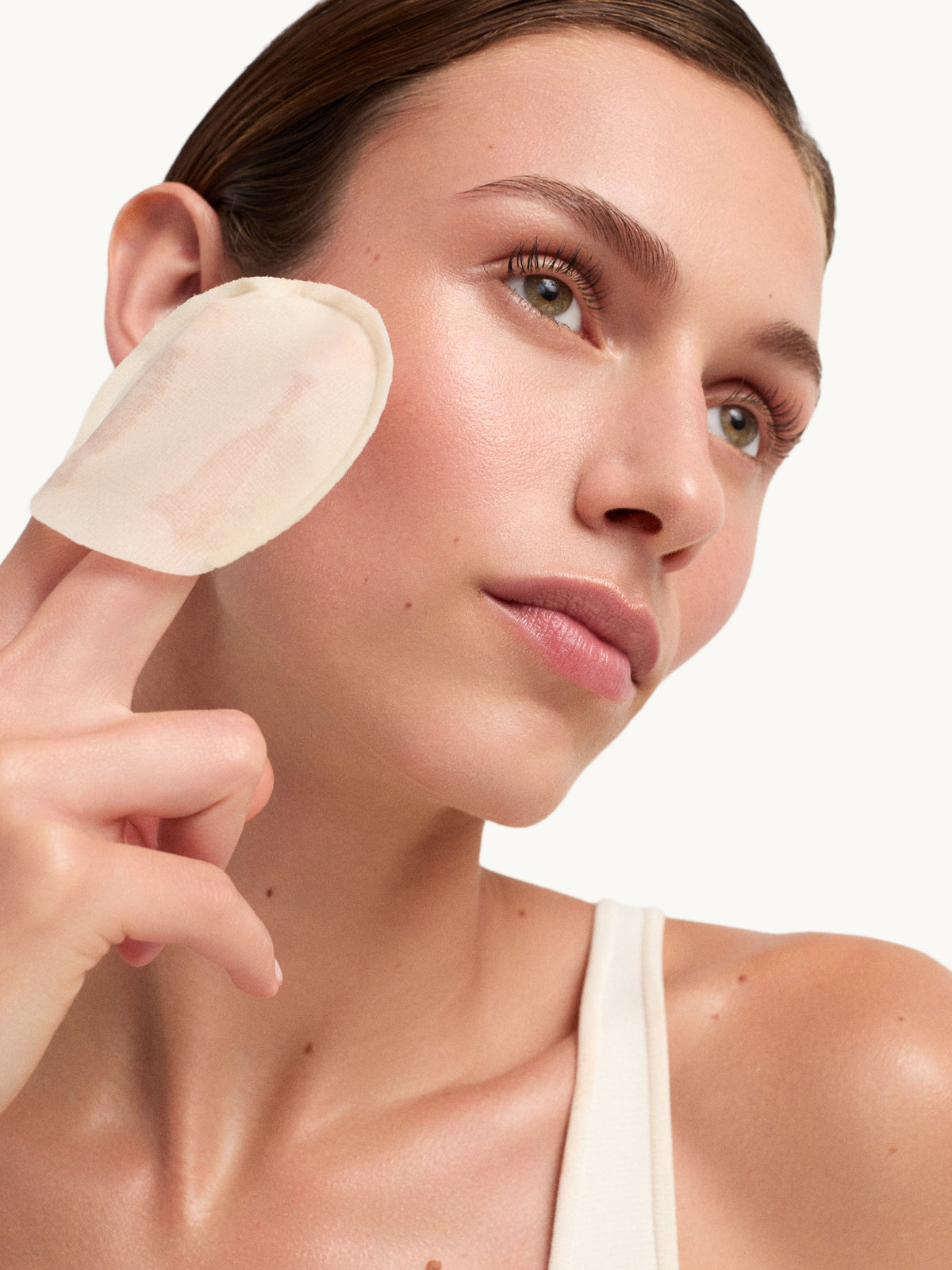 Model applying goop beauty 15% Glycolic Acid Overnight Glow Peel