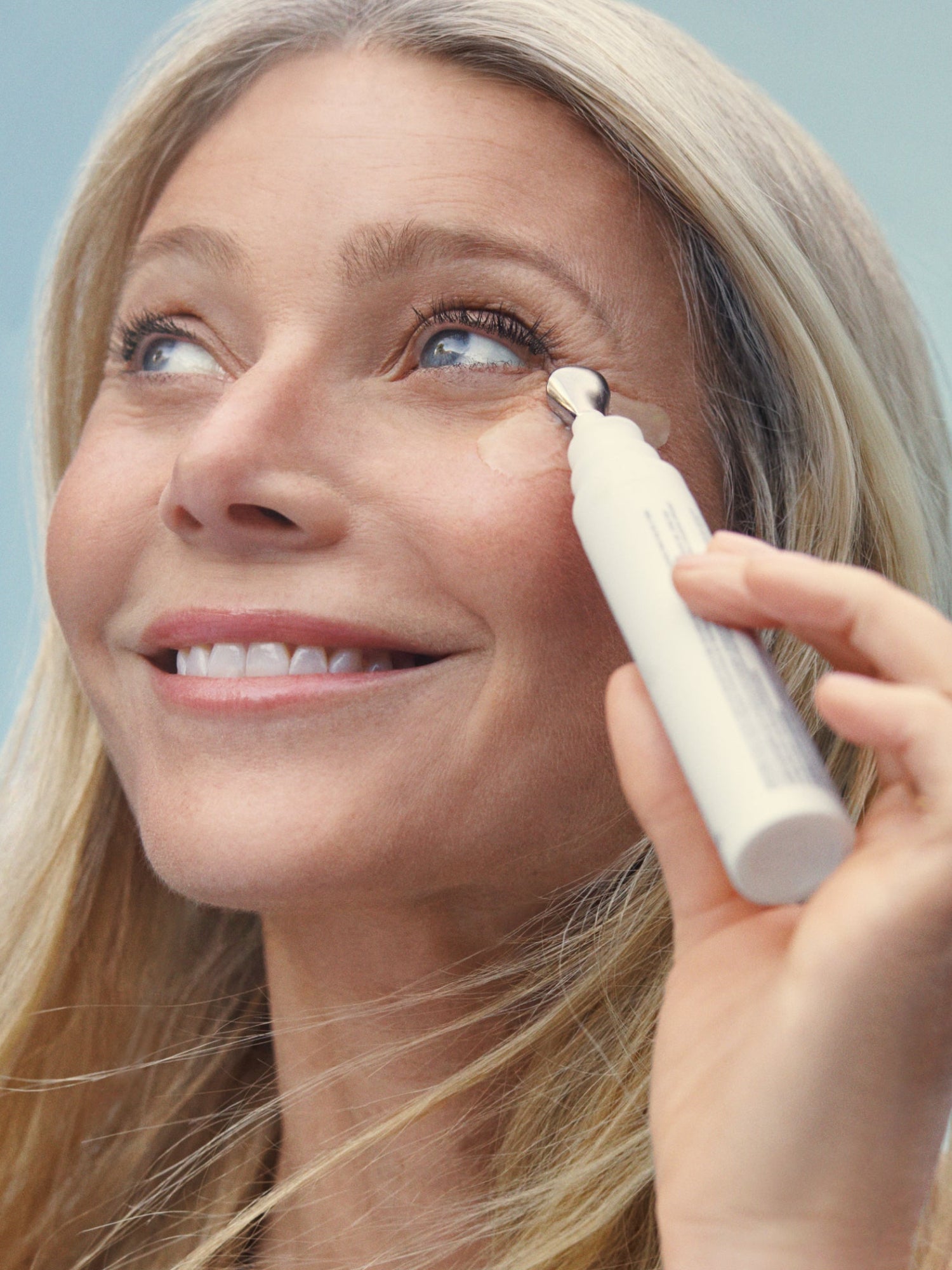 Applying goop beauty 3x Retinol Eye Lift Serum around the eye area