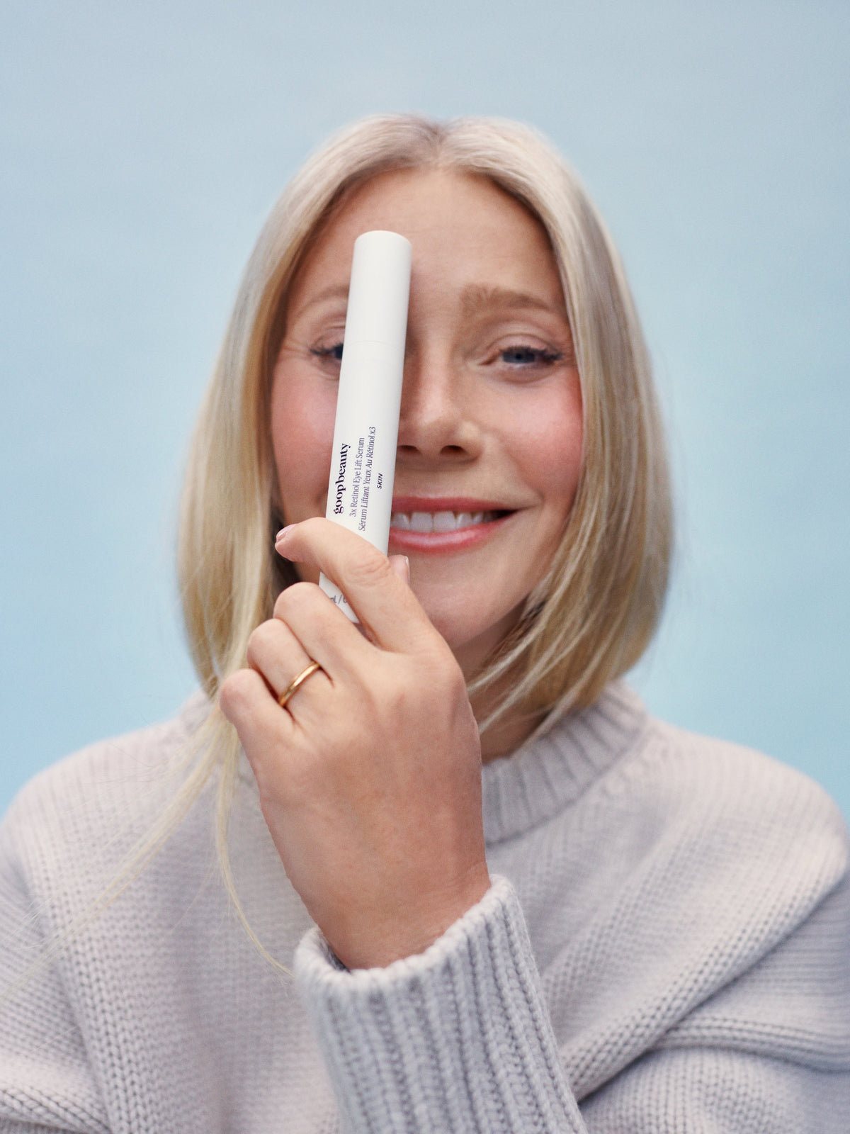 Model holding goop beauty 3x Retinol Eye Lift Serum