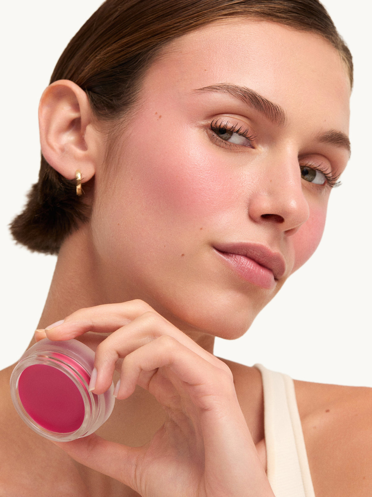 Model holding goop beauty Colorblurb Glow Balm Venus