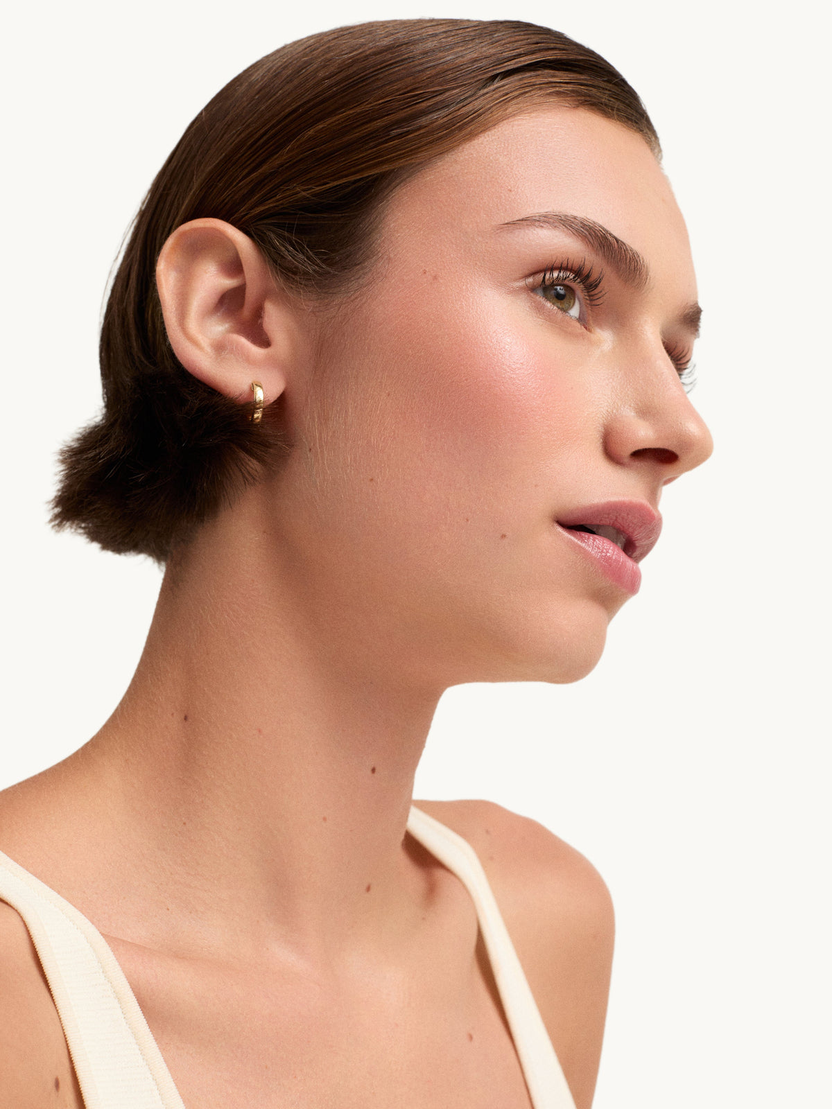 goop beauty Colorblurb Glow Balm Whiskey swatch on cheek