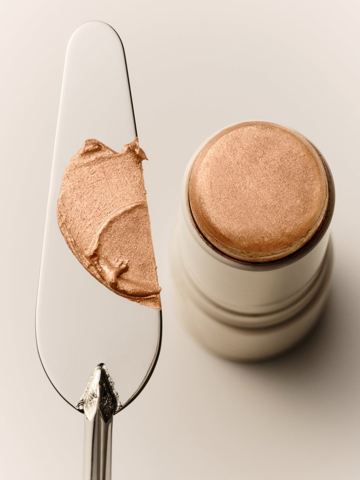 GOOP BEAUTY Glow Skin Highlighter Stick in Sunny swatch showing the luminous champagne shade