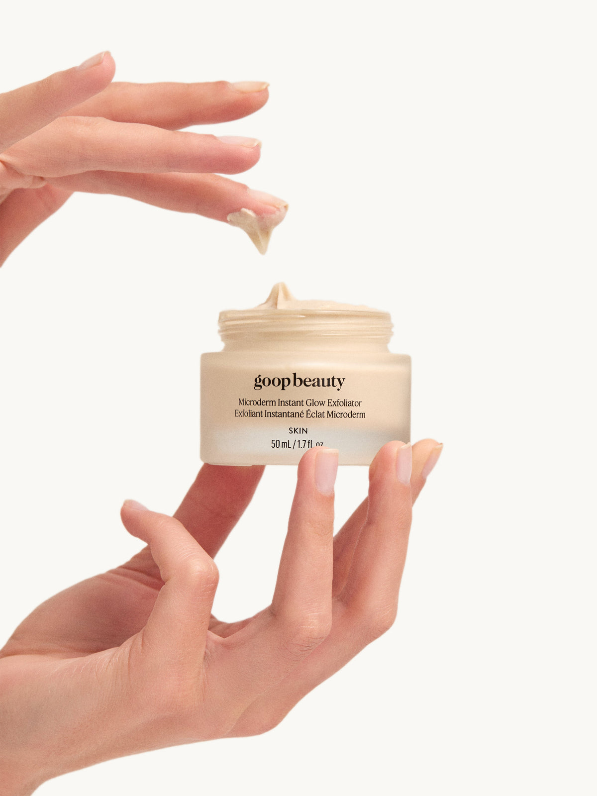 goop Microderm Instant Glow Exfoliator skincare product with hands