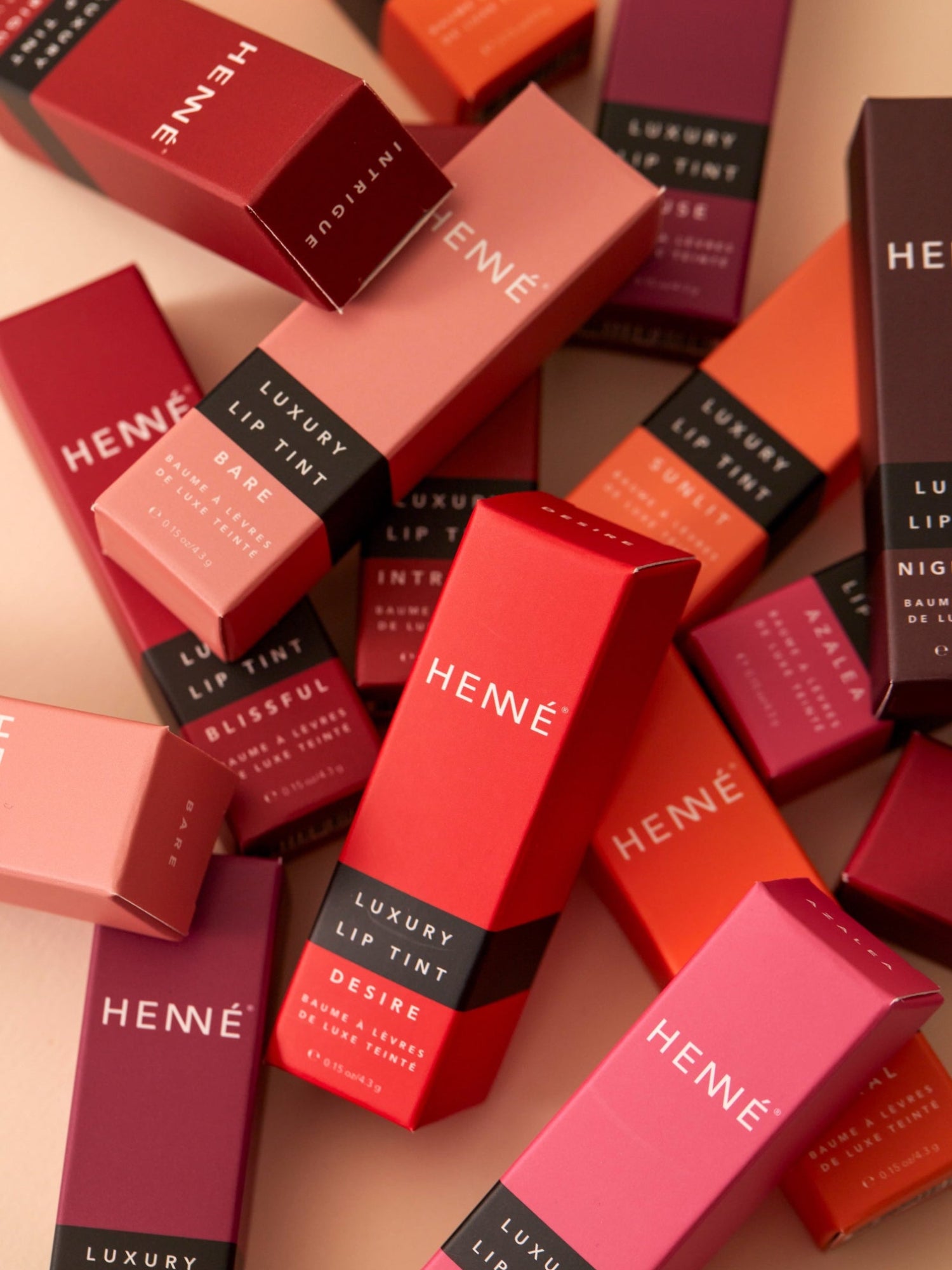 HENNÉ ORGANICS Luxury Lip Tint collection in colorful packaging
