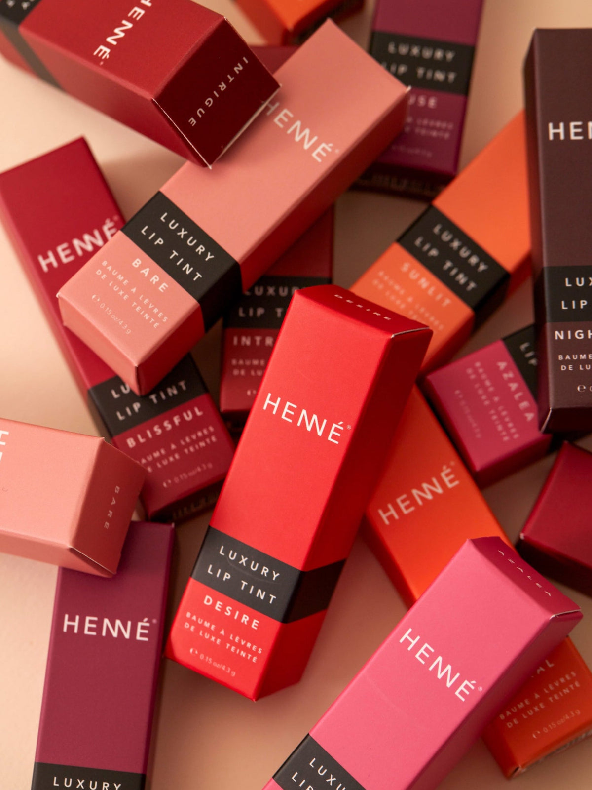 HENNÉ ORGANICS Luxury Lip Tint collection in colorful packaging