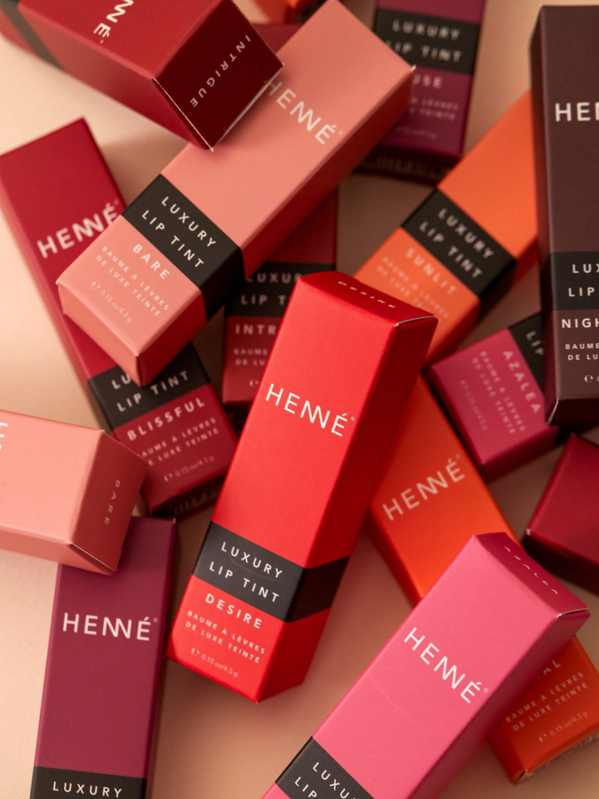 HENNÉ ORGANICS Luxury Lip Tint collection in colorful packaging