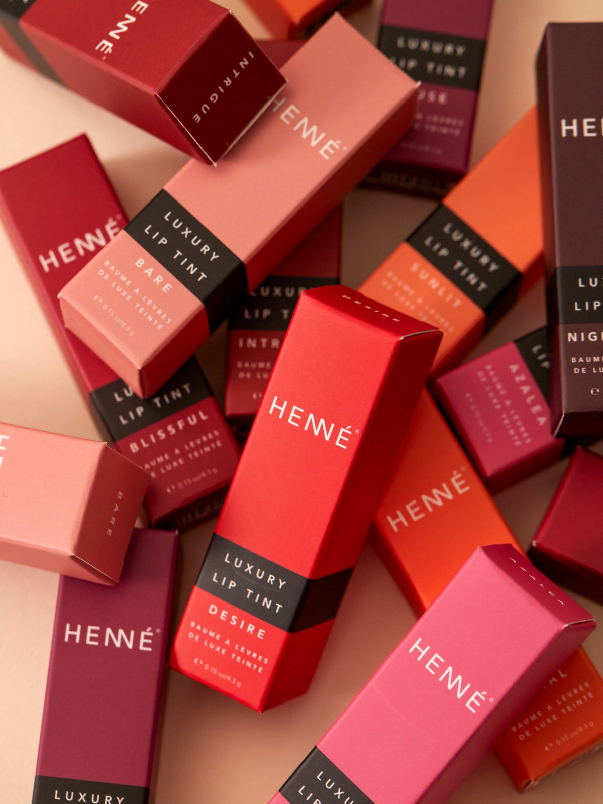 HENNÉ ORGANICS Luxury Lip Tint collection in colorful packaging