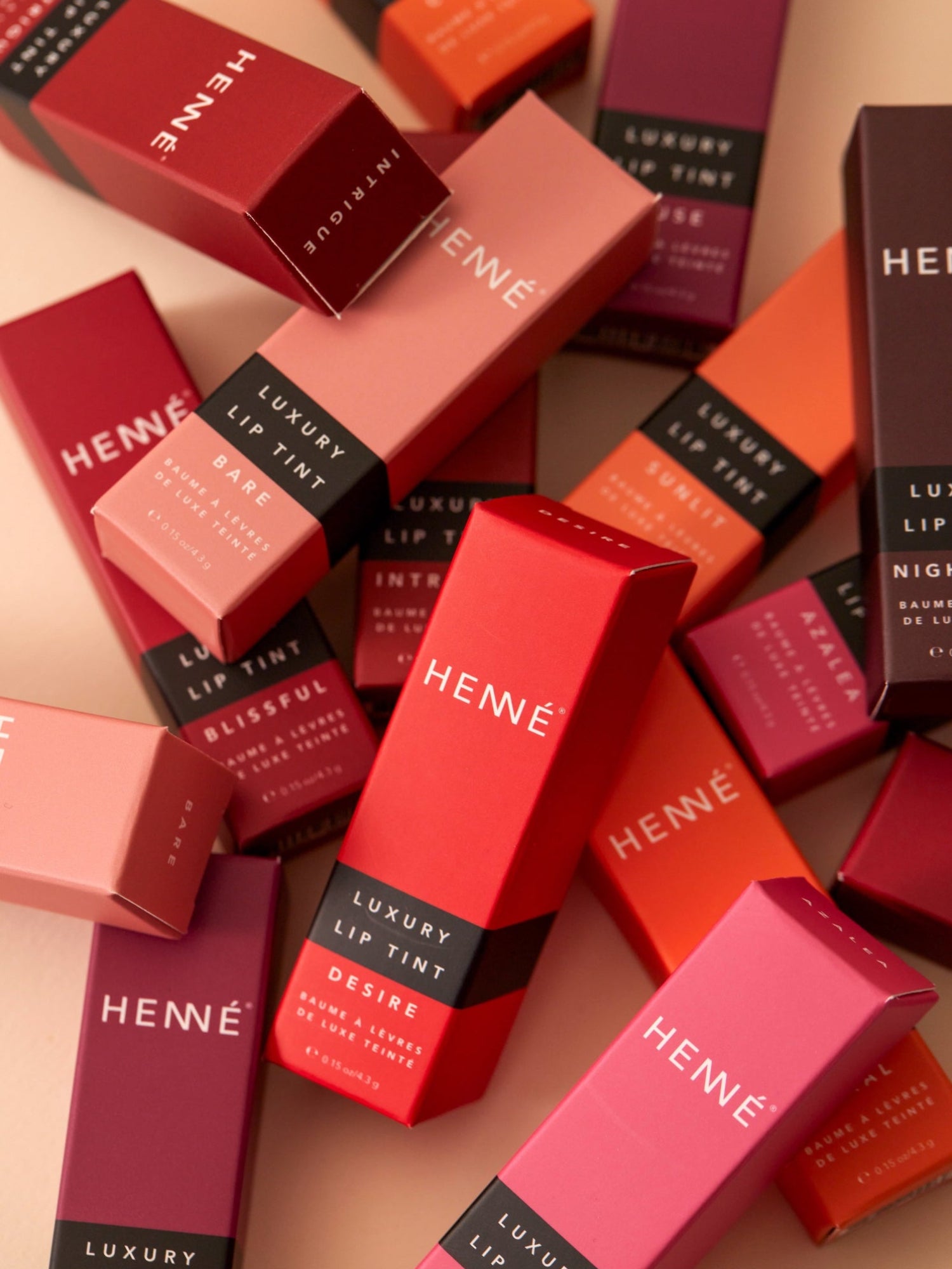 HENNÉ ORGANICS Luxury Lip Tint collection in colorful packaging
