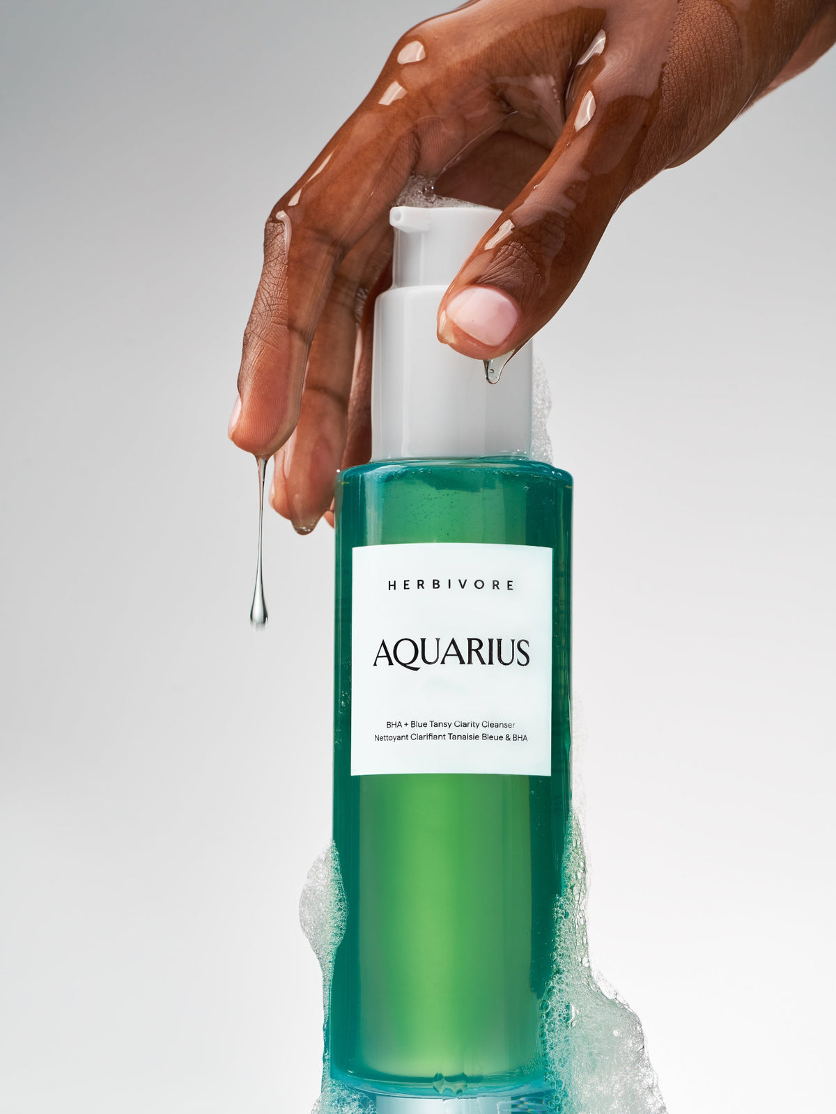 Herbivore Botanicals Aquarius BHA + Blue Tansy Clarity Cleanser applied to skin