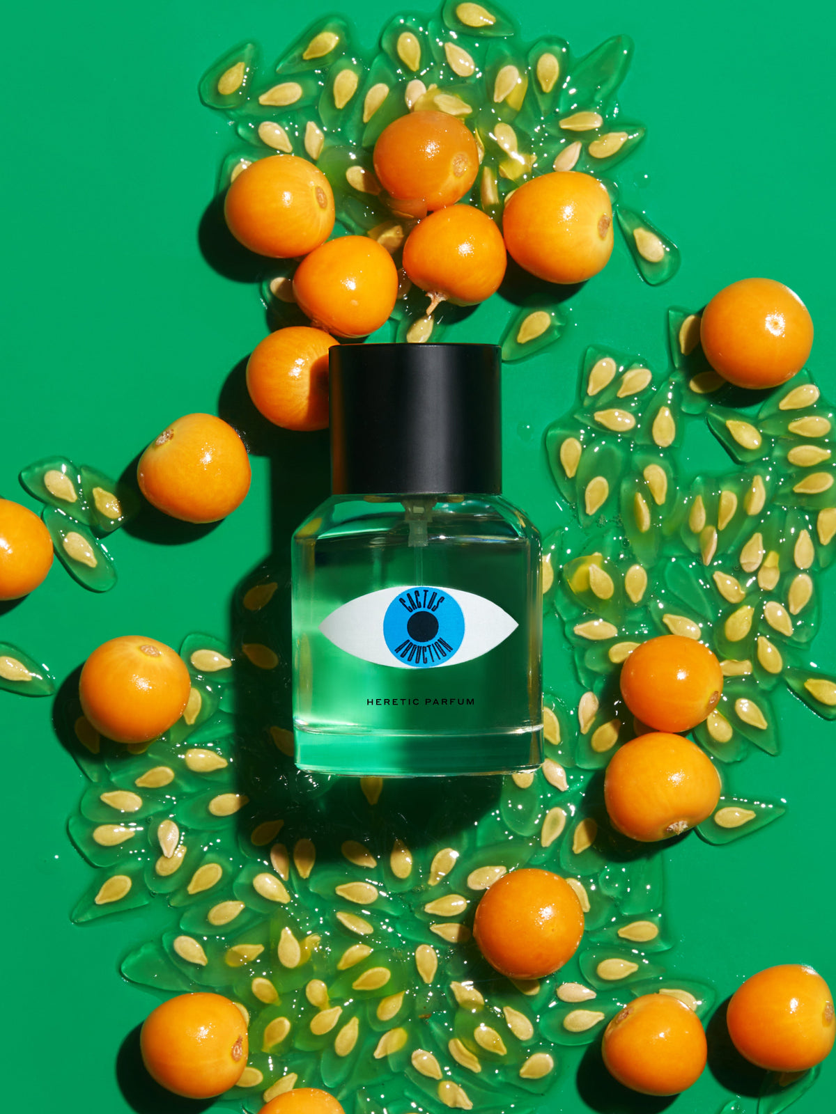 Heretic Parfum Cactus Abduction Eau de Parfum surrounded by oranges and seeds