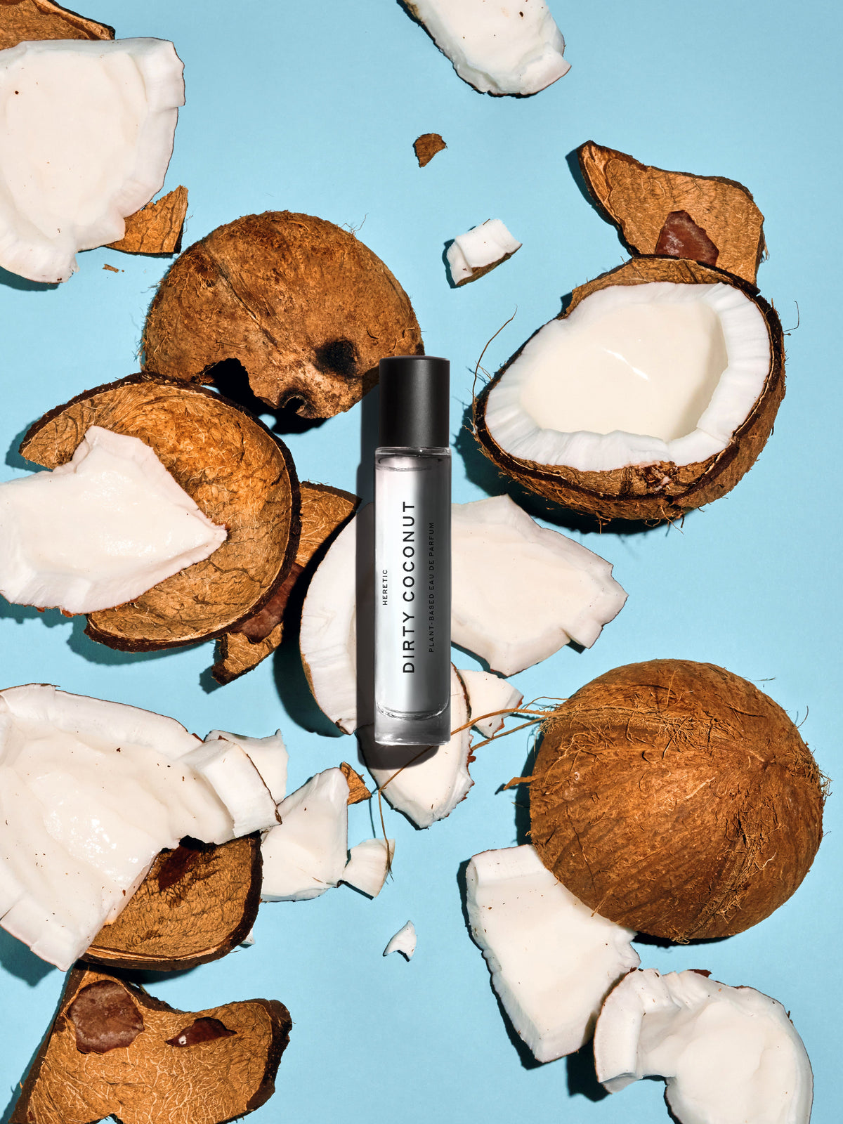 Heretic Parfum Dirty Coconut Eau de Parfum bottle with fresh coconut