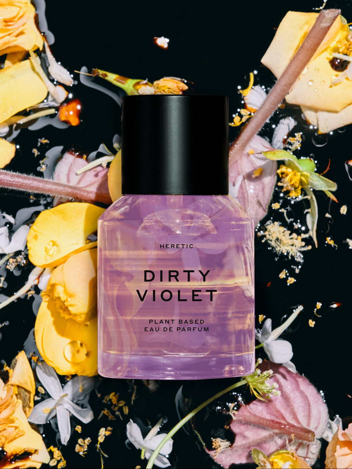 Heretic Parfum Dirty Violet Eau de Parfum surrounded by flowers