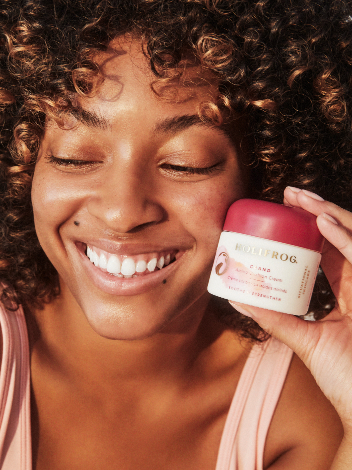 Model holding HOLIFROG Grand Amino Cushion Cream