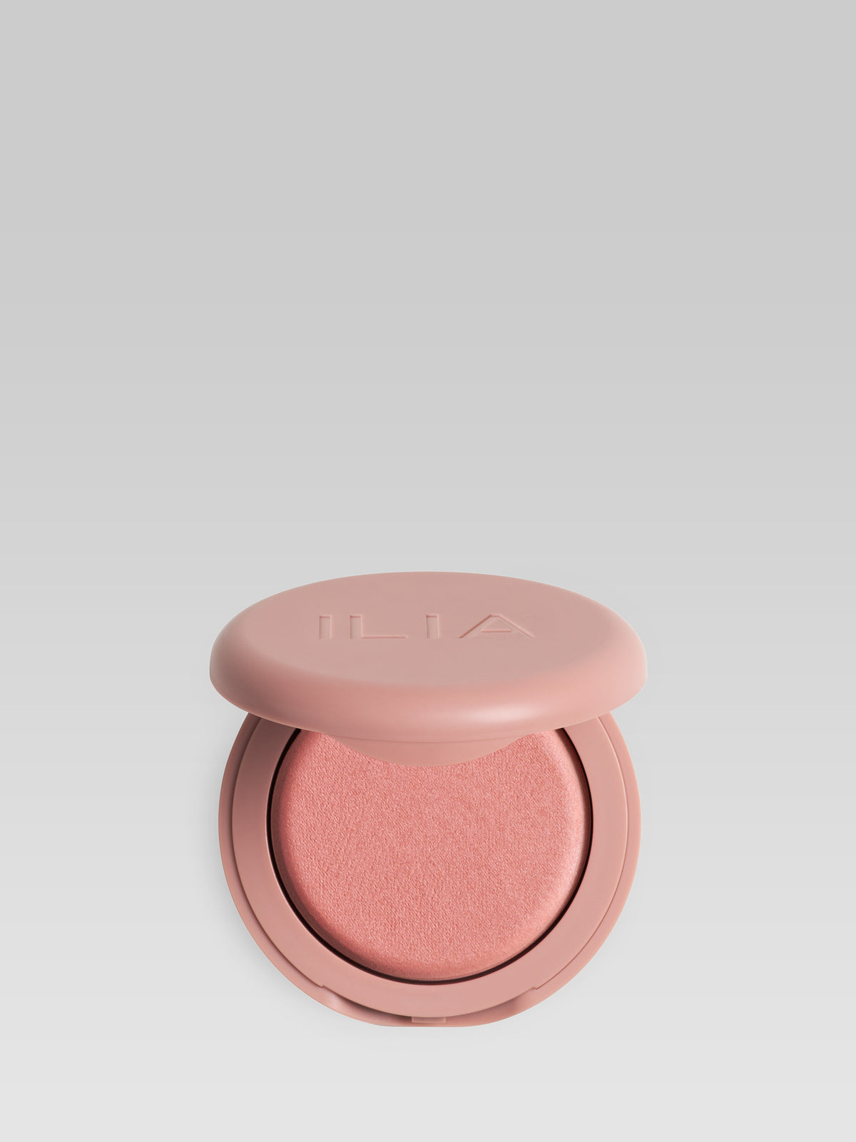ILIA Beauty Soft Focus Blurring Blush in Flutter, a warm peach powder blush in a pink compact
