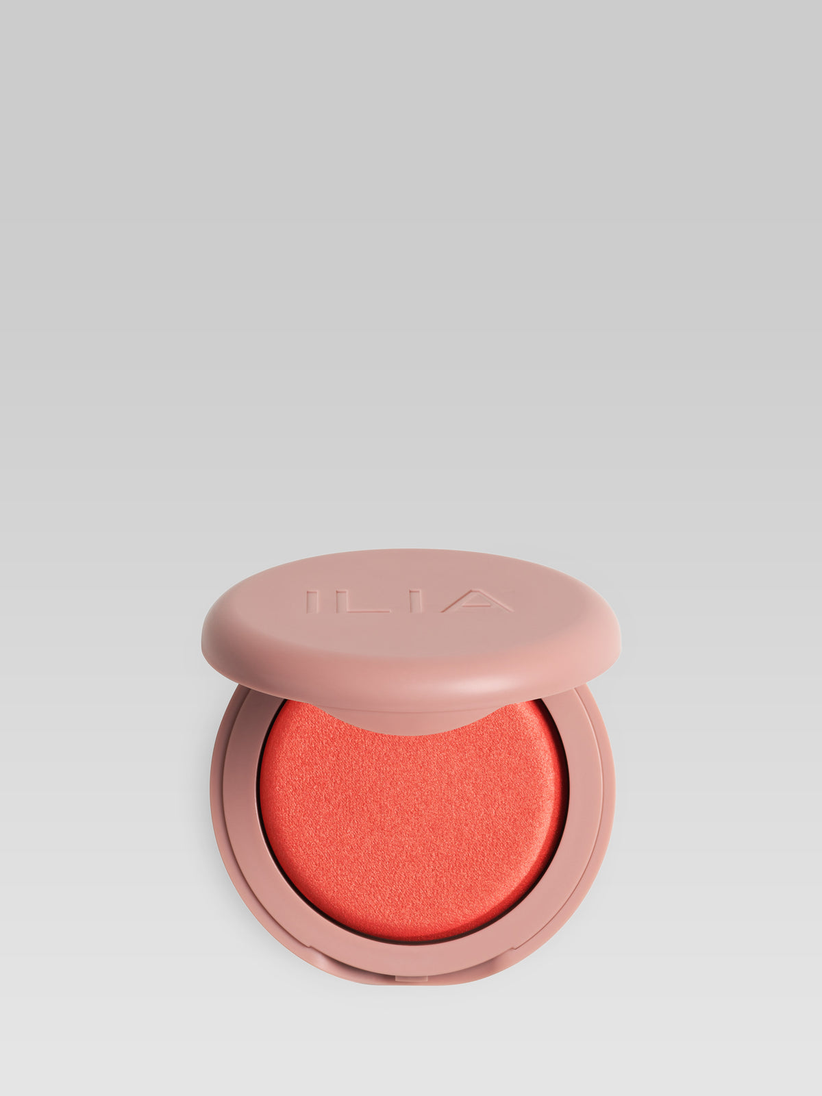ILIA Beauty Soft Focus Blurring Blush in Pulse, a bright coral powder blush in a pink compact