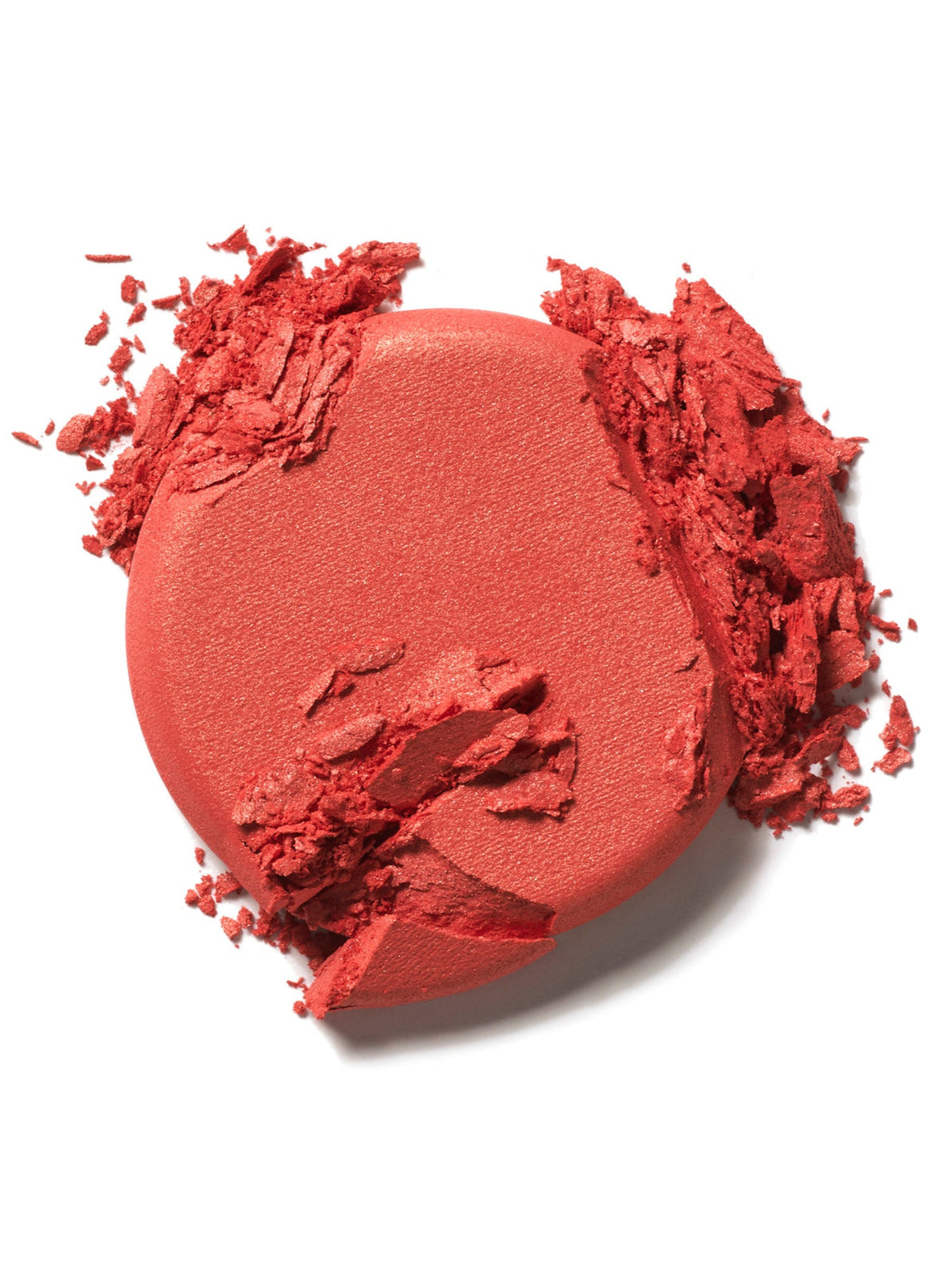 ILIA Beauty Soft Focus Blurring Blush in Pulse, a bright coral powder blush swatch with crushed pigment on a white background