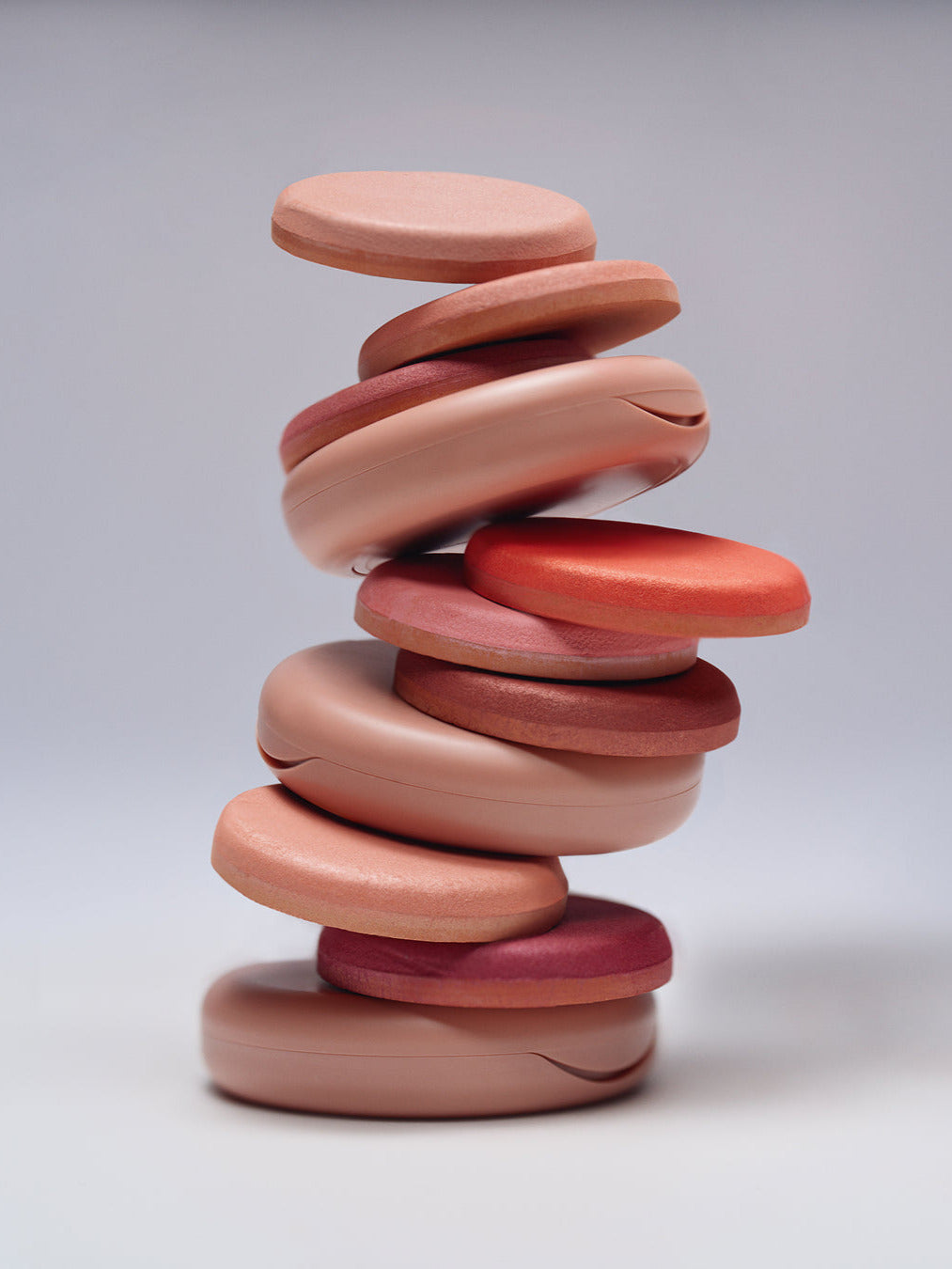 ILIA Beauty Soft Focus Blurring Blush compacts stacked in a tower of pink, rose and coral shades