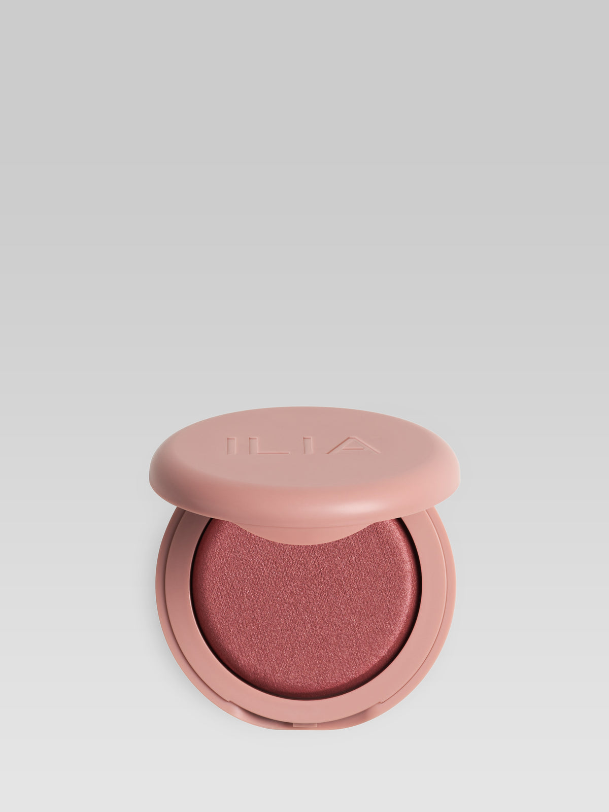 ILIA Beauty Soft Focus Blurring Blush in Wonder, a deep terracotta powder blush in a pink compact