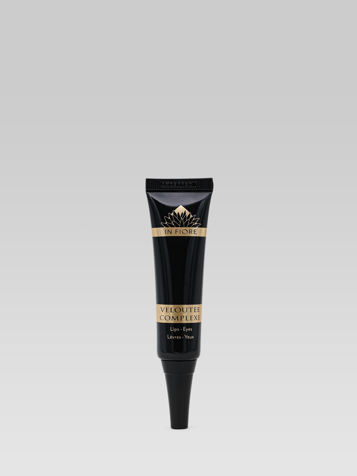 IN FIORE Veloutée Complexe Lip and Eye Balm in black tube with gold lettering on a light grey background