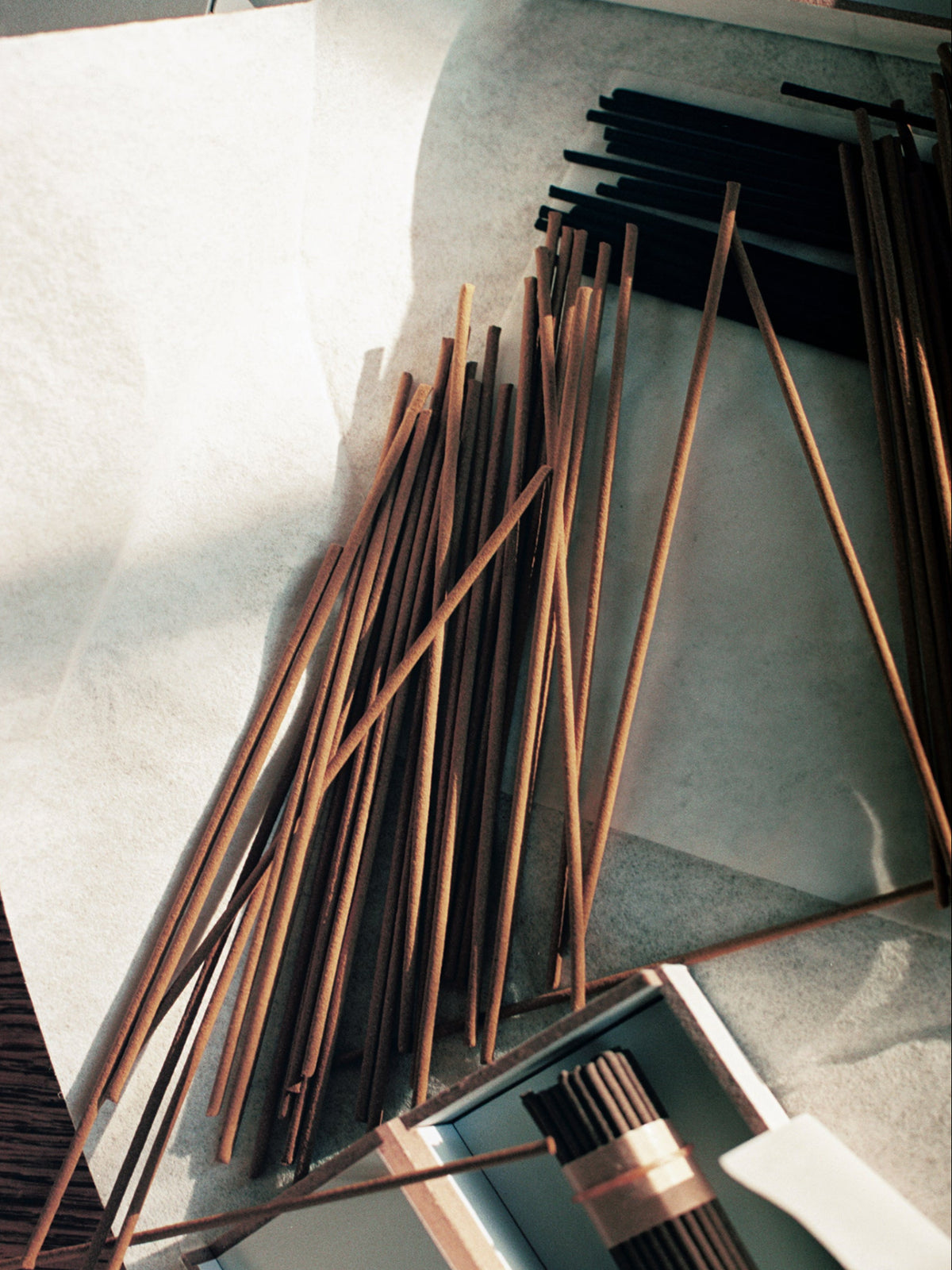 JJIMJIL Cypress Incense sticks arranged in warm brown and black tones, highlighting the minimalist design and natural aesthetic of the incense