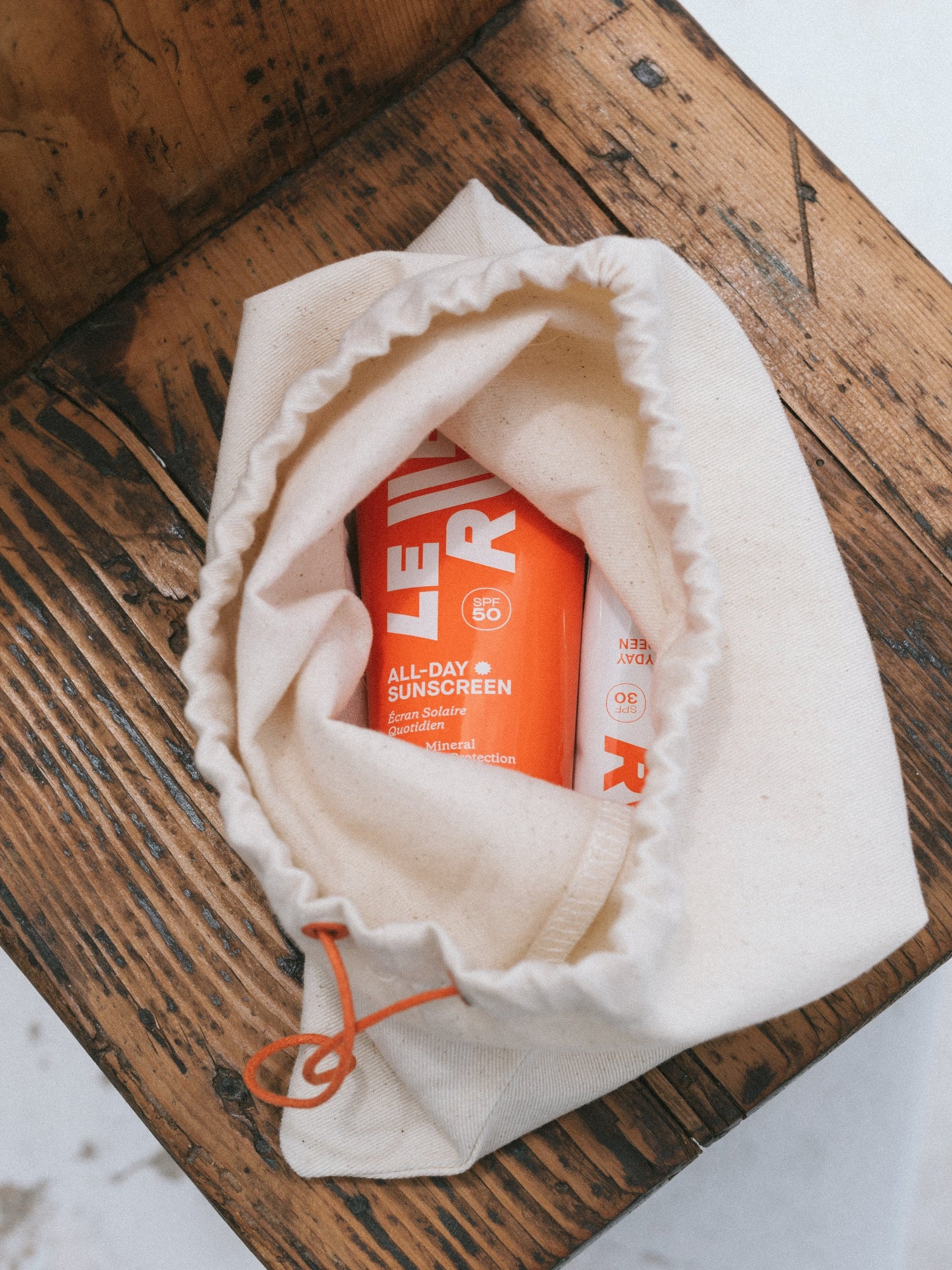 LE RUB All-Day Sunscreen SPF 50 in a cotton pouch