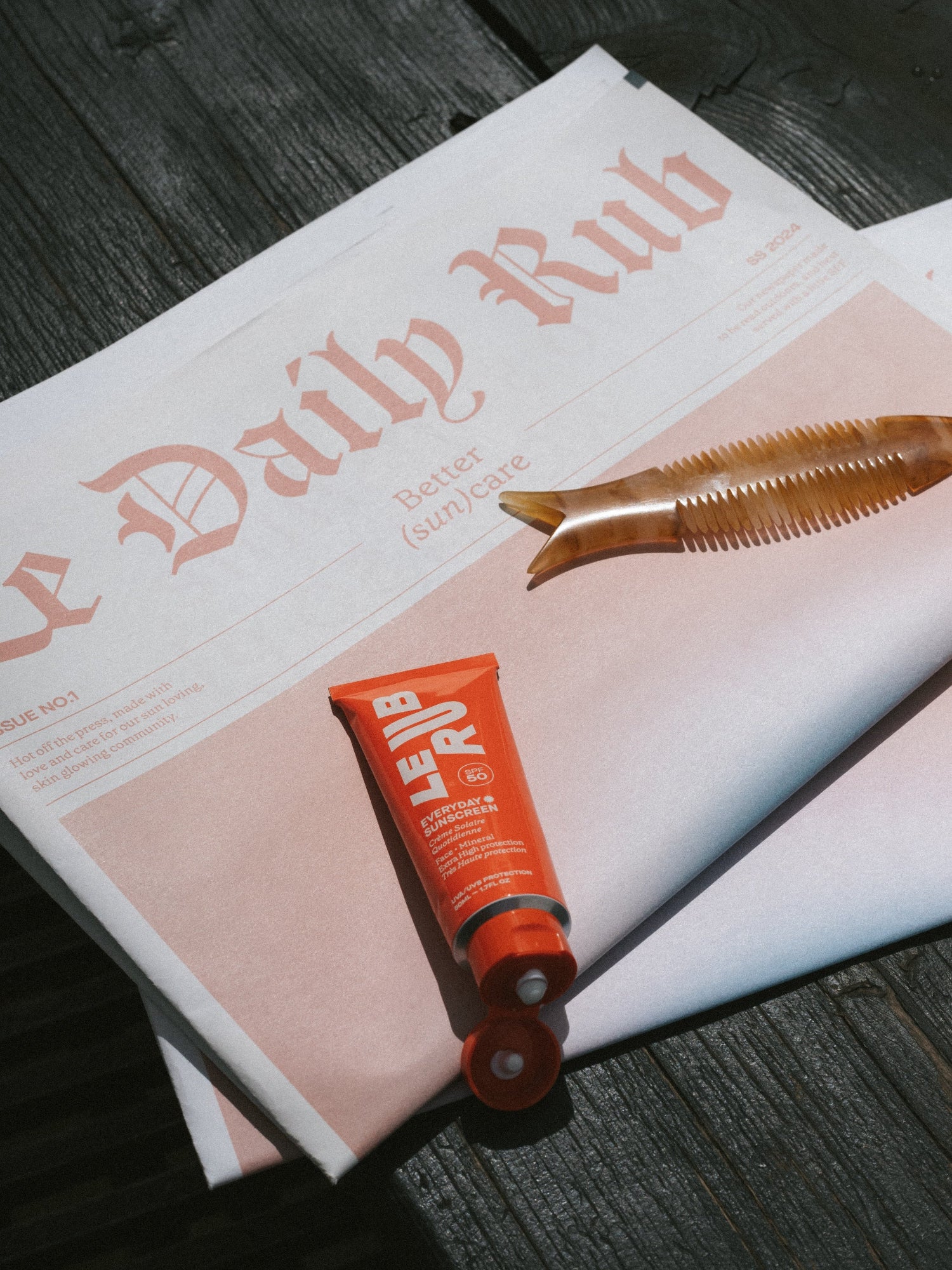 LE RUB Everyday Sunscreen SPF 50 on a newspaper