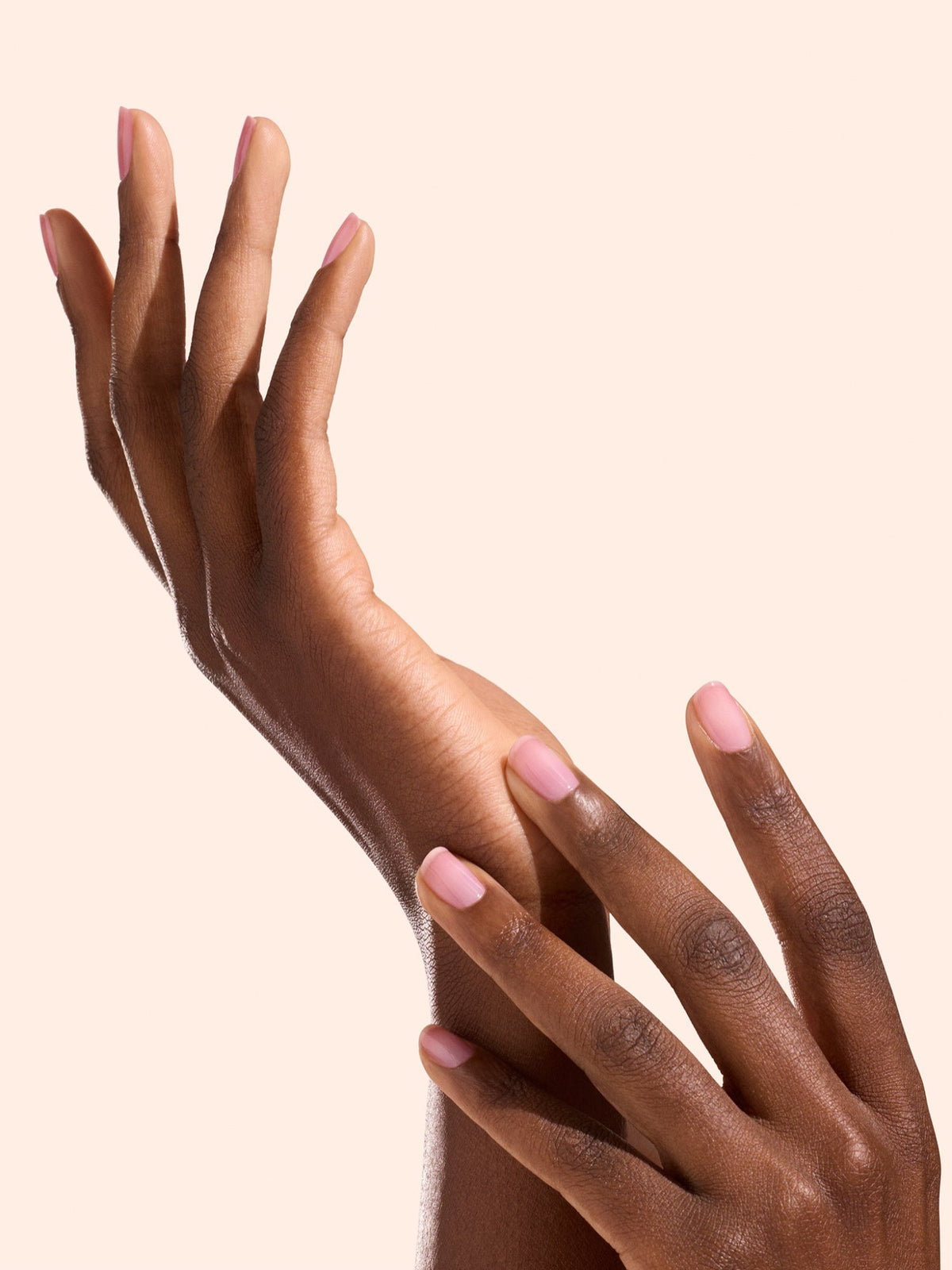 Hands with glossy pink nails using MANUCURIST Active Glow Grape