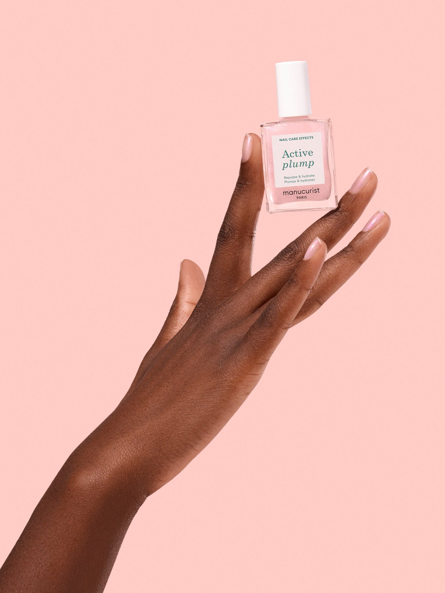 MANUCURIST Active Plump nail care treatment held in hand