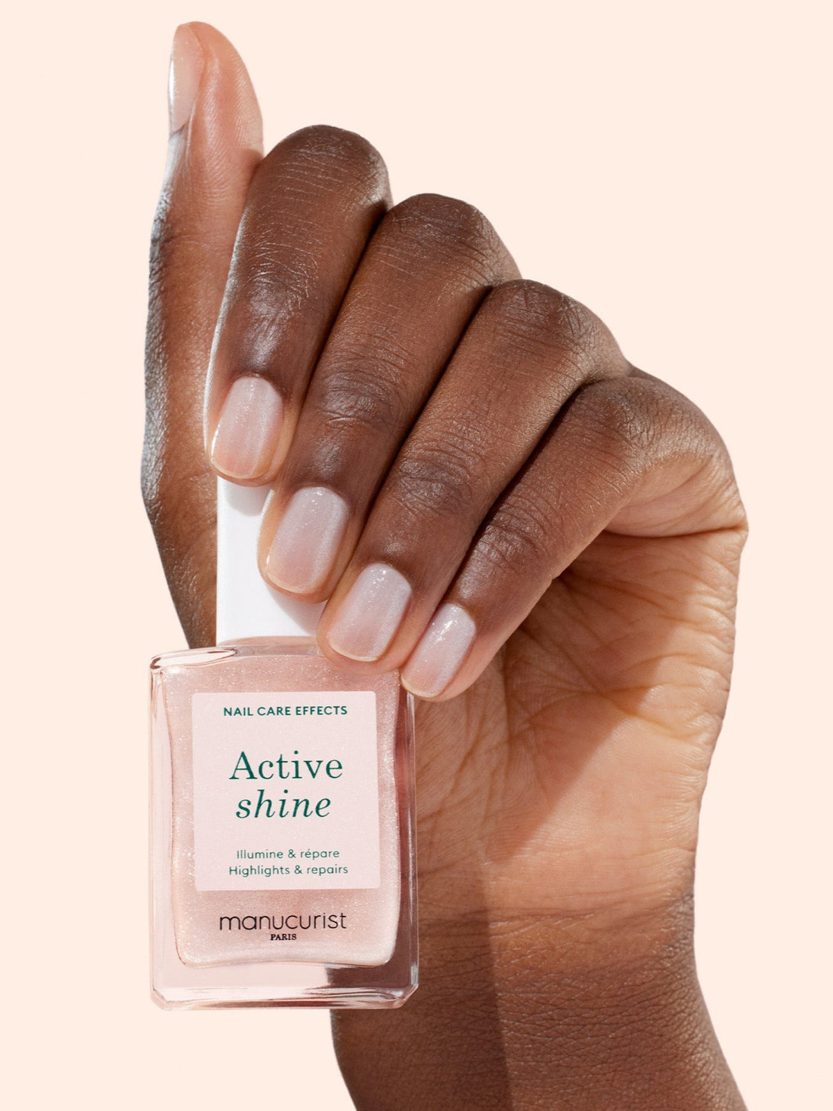 MANUCURIST Active Shine nail treatment held in hand