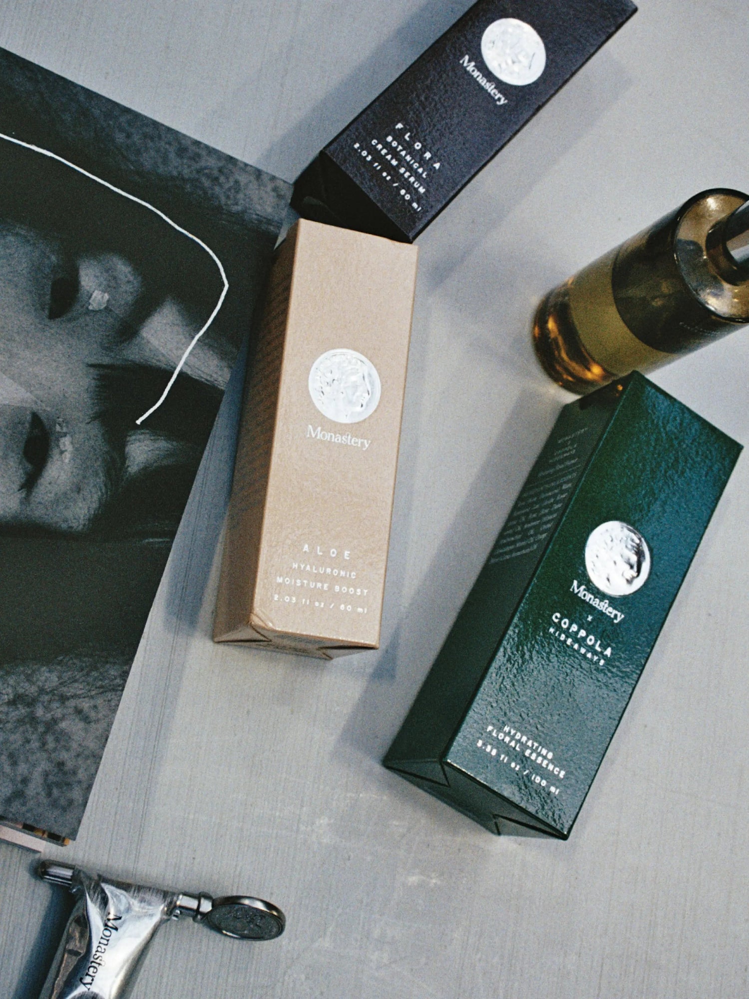 MONASTERY Aloe Hyaluronic Moisture Boost with skincare packaging in an editorial still life