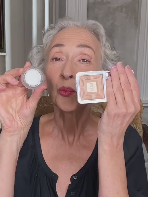 RMS Beauty founder Rose-Marie Swift comparing the Living Luminizer with another highlighter, demonstrating the products on camera