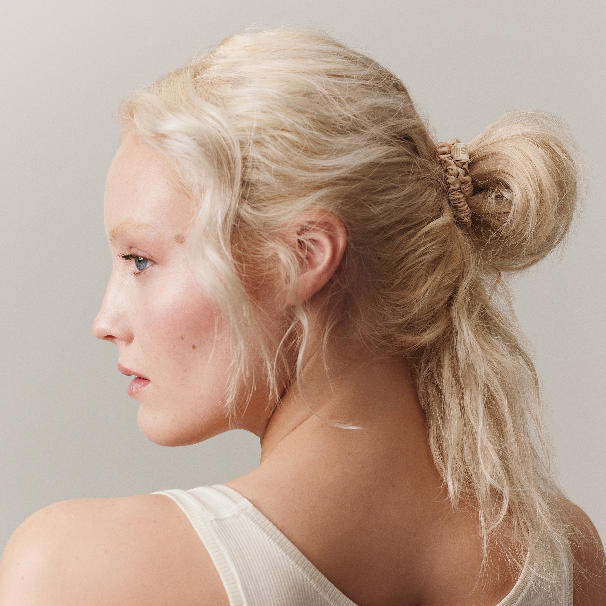 SLIP Blonde silk hair tie styled in model's hair