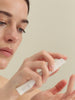 PAI Skincare Light Work Rosehip Fruit Extract Cleansing Oil applied to the face