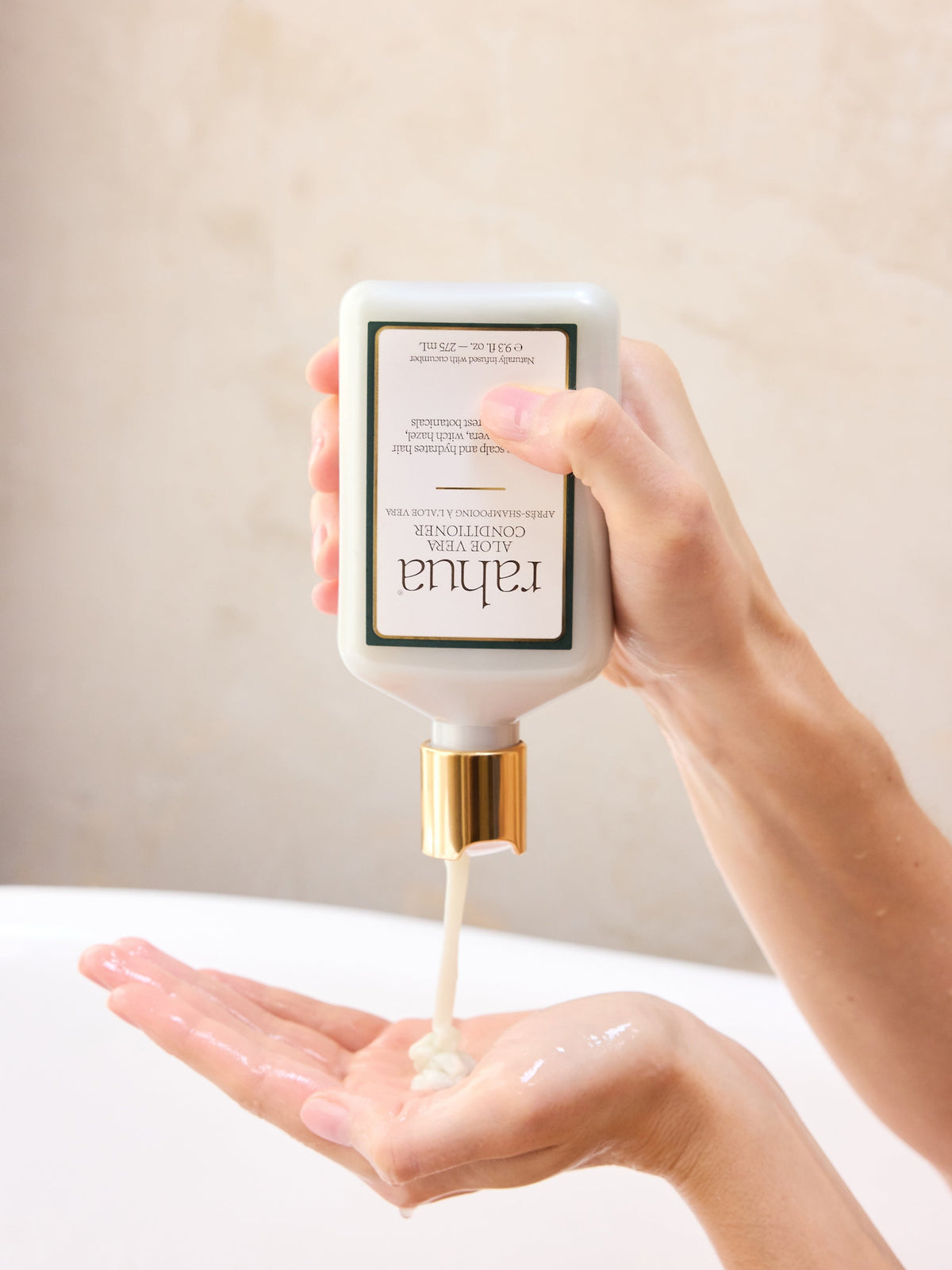 Rahua Aloe Vera Conditioner being applied to hair for hydration and nourishment