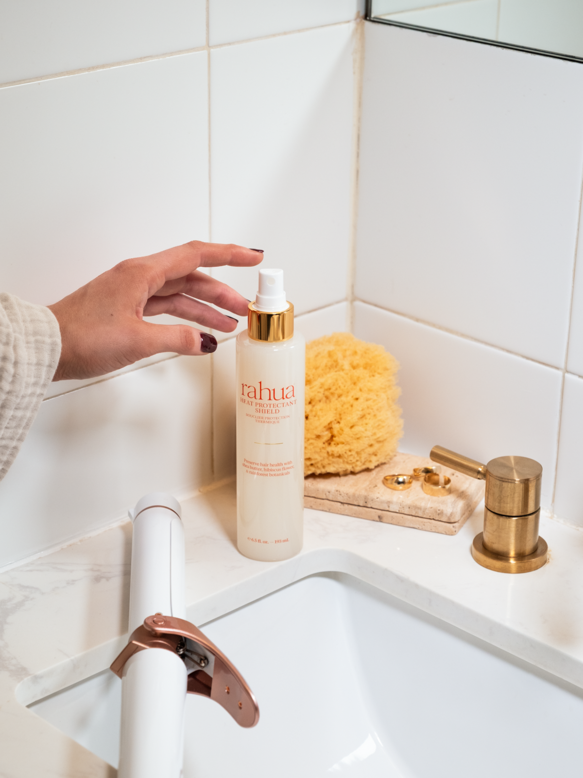 Rahua Heat Protectant Shield hair treatment in a bathroom for protecting hair from heat styling