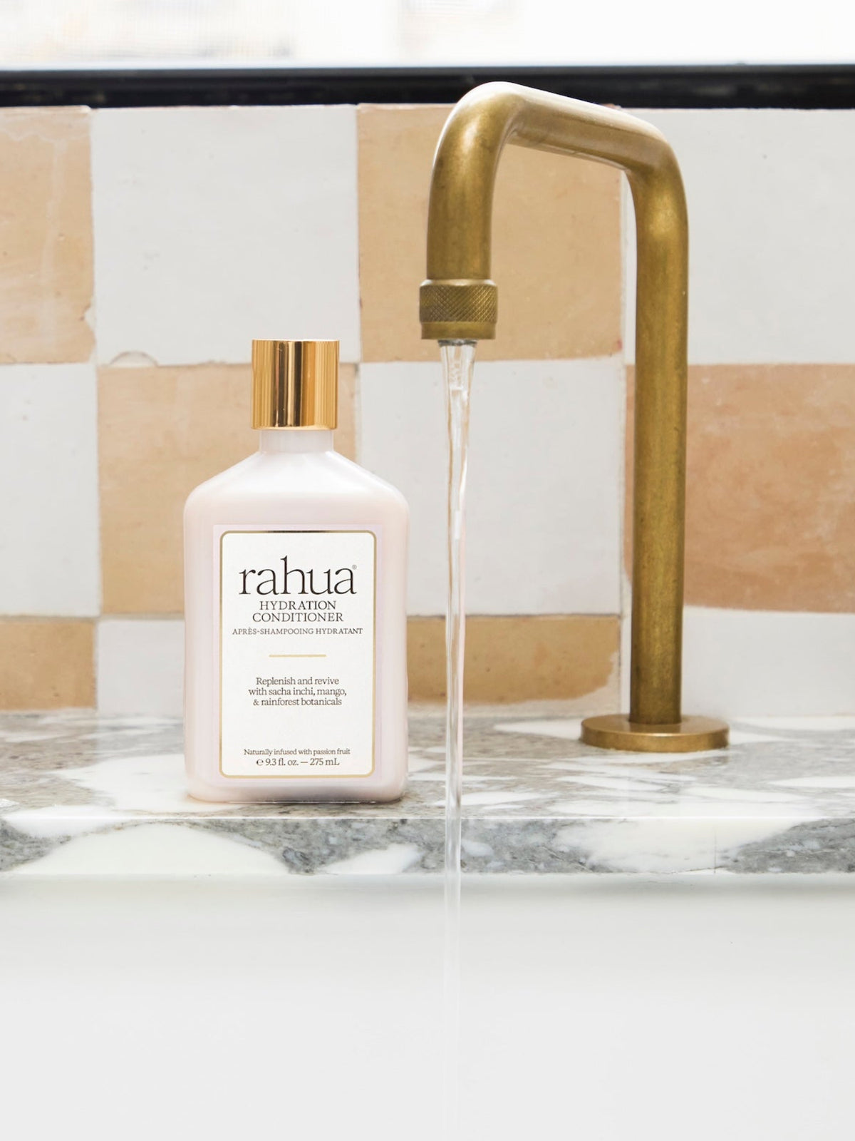 Rahua Hydration Conditioner 275 ml displayed beside a bathroom faucet