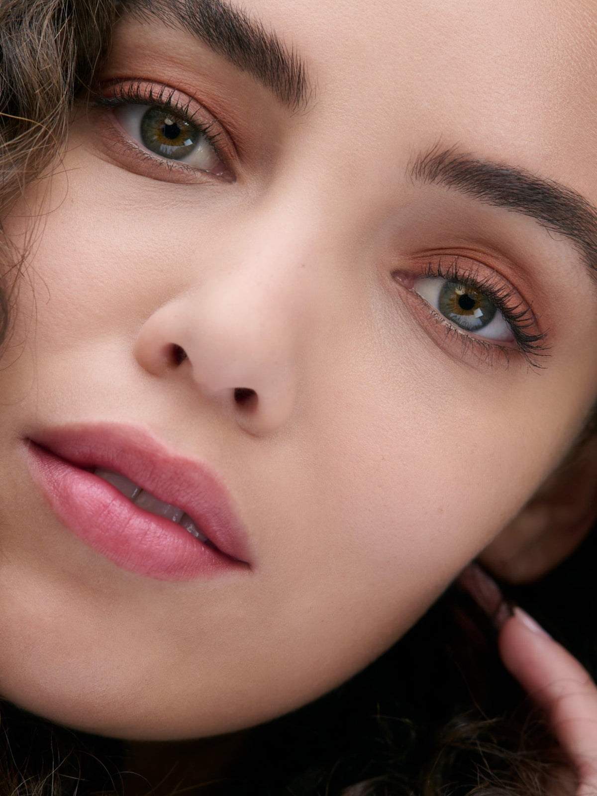 Close-up of a model wearing RMS Beauty Cashmere Matte Eyelights in Canyon Clay, a warm terracotta matte eyeshadow