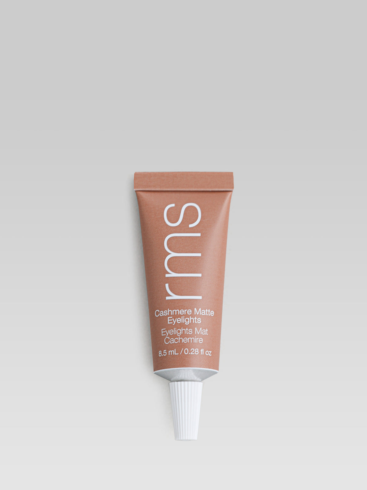 RMS Beauty Cashmere Matte Eyelights in Dusty Trail in a warm terracotta-brown squeeze tube