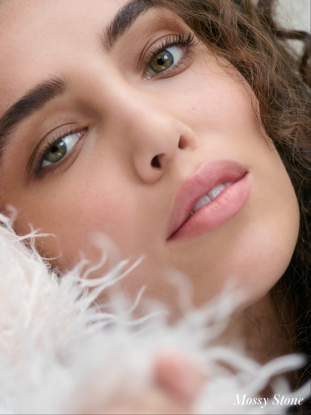 Close-up of a model wearing RMS Beauty Cashmere Matte Eyelights in Mossy Stone