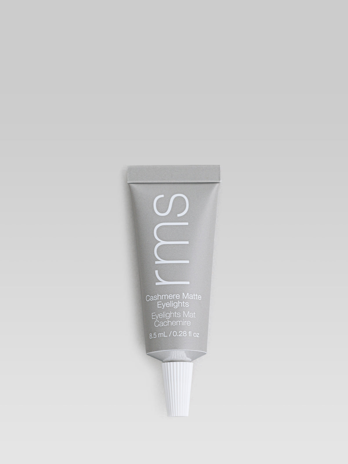 RMS Beauty Cashmere Matte Eyelights in Mountain Mist, a light grey-beige matte cream eyeshadow in a squeeze tube