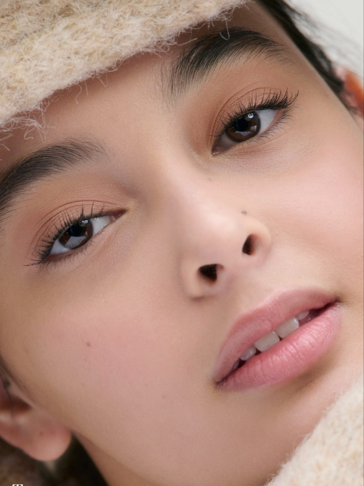 Model wearing RMS Beauty Cashmere Matte Eyelights in Tundra Taupe, showcasing the soft matte eye makeup