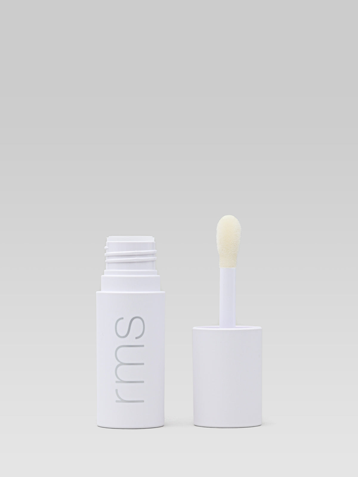 RMS BEAUTY Legendary Lip Oil in Adrianna with the applicator removed, showing the lip oil container and applicator