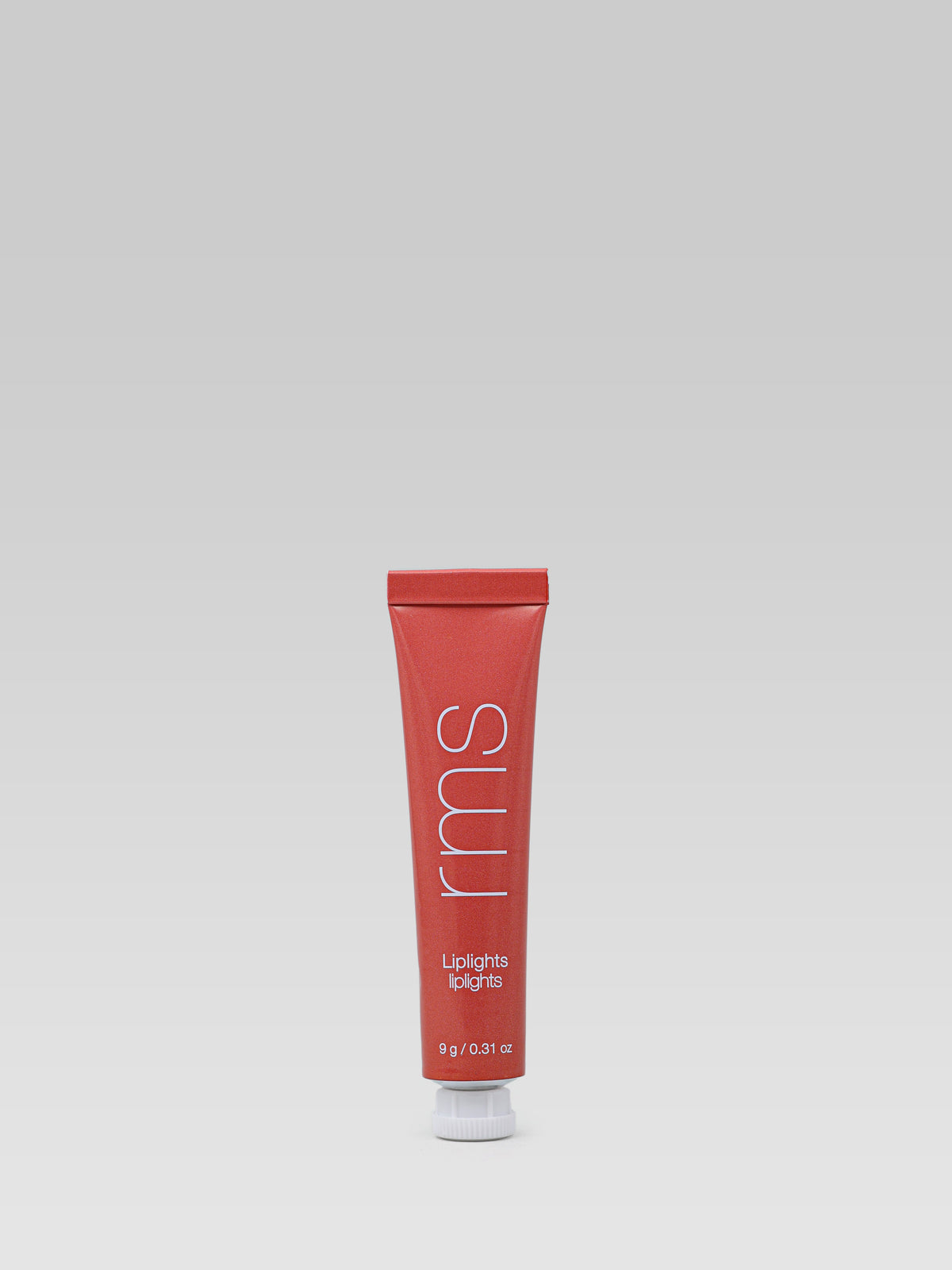 RMS Beauty Lip Lights Cream Lip Gloss in Crush in a coral-red squeeze tube against a neutral background