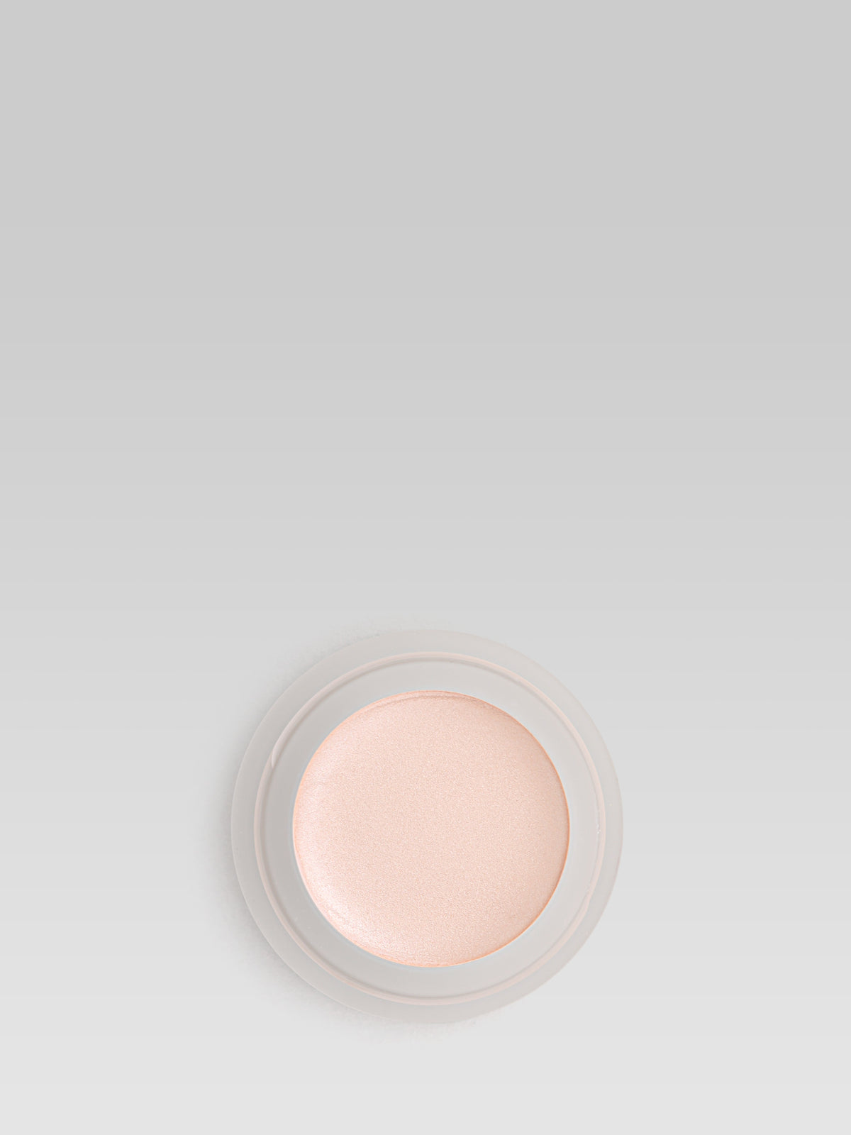 RMS Beauty Magic Luminizer cream highlighter in a luminous champagne shade, shown in an open round pot against a light background