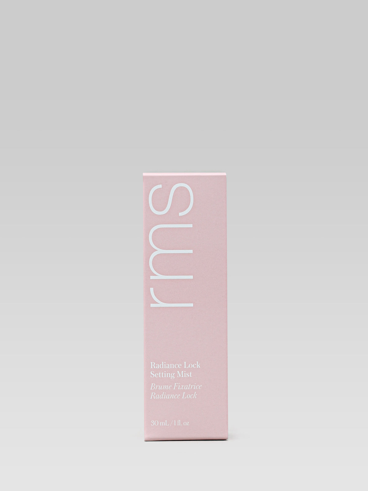 RMS Beauty Radiance Lock Setting Mist 30 ml travel size pink carton packaging against a light grey background