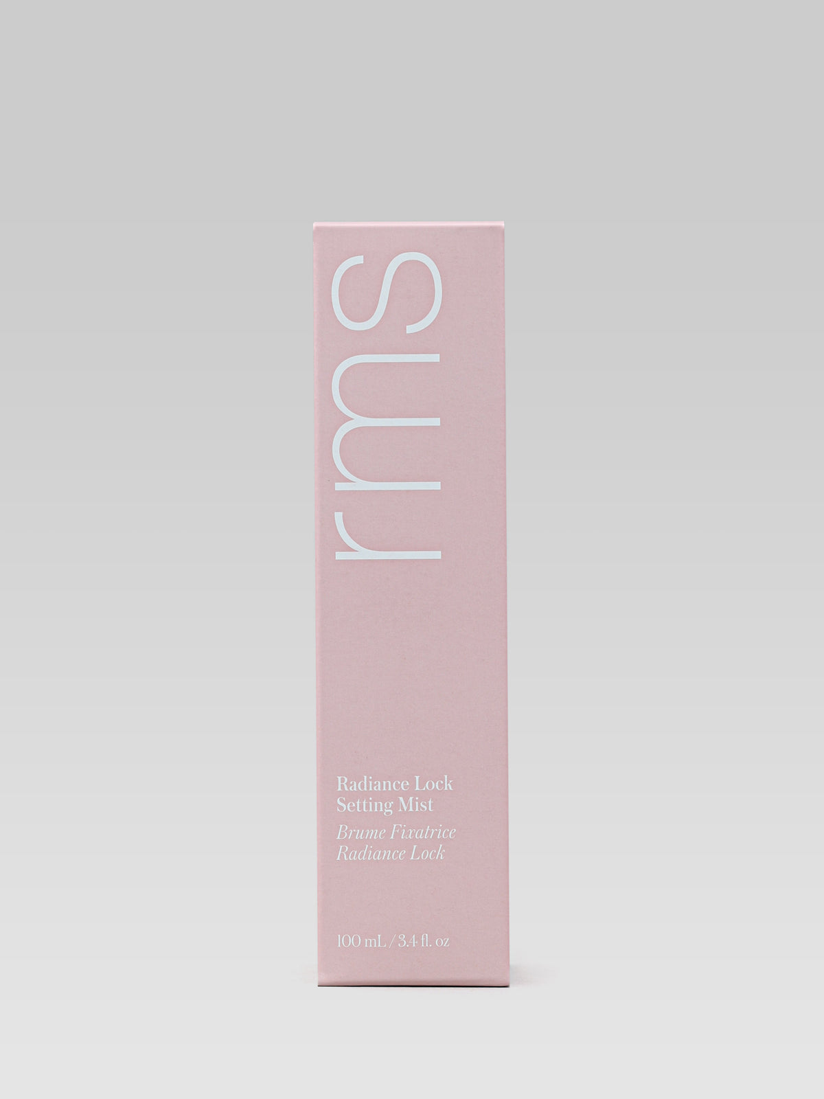 RMS Beauty Radiance Lock Setting Mist 100 ml pink carton packaging photographed against a light grey background