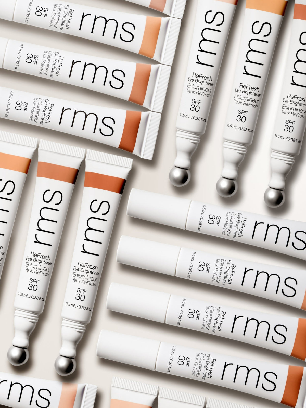 RMS BEAUTY ReFresh Eye Brightener SPF 30 + Correcting Tint tubes arranged in a flat lay